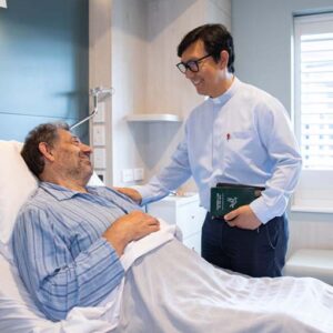 A hospital chaplain with a patient.