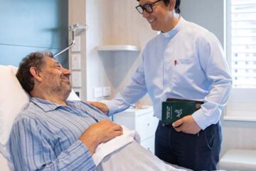 A hospital chaplain with a patient.