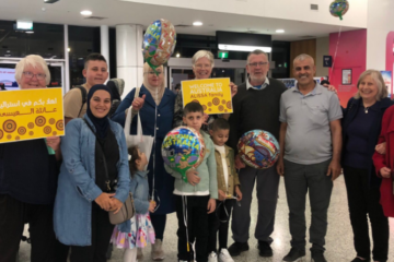 A Blue Mountains-based refugee family are greeted by local sponsors on arrival to Sydney. Image: Supplied.