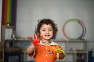 Child at a playgroup with paint on his hands. Image: Pixabay.