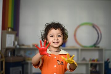 Child at a playgroup with paint on his hands. Image: Pixabay.