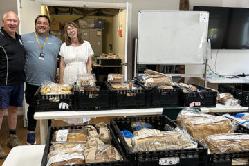 Catholic Care staff with donated foodstuffs from OzHarvest. Image: Diocese of Parramatta